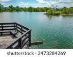 A view of the nesting island at Kountze Lake and surrounding trees and mountains from the viewing deck at Belmar Park in Lakewood, Colorado.