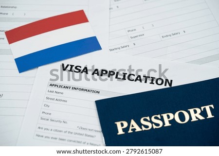 View of Netherlands visa application form with passport and national flag.