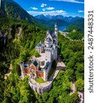 A view of Neuschwanstein Castle,  a 19th-century fairy-tale-like palace perched on a rugged hill above the village of Hohenschwangau in southwest Bavaria, Germany, Europe