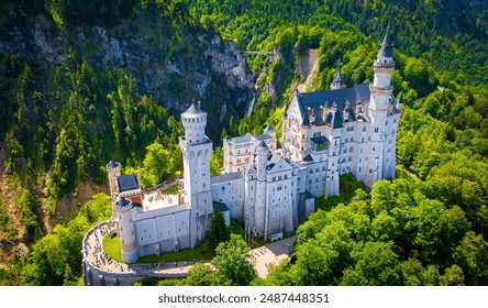 A view of Neuschwanstein Castle,  a 19th-century fairy-tale-like palace perched on a rugged hill above the village of Hohenschwangau in southwest Bavaria, Germany, Europe - Powered by Shutterstock