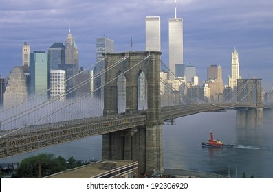 View of New York skyline, Brooklyn Bridge over the East River and tugboat in fog, NY - Powered by Shutterstock