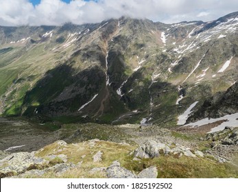 view from Niederl saddle on Nurnberger Hutte mountain hut and snow-capped peaks at Stubai hiking trail, Stubai Hohenweg, Summer rocky alpine landscape of Tyrol, Stubai Alps, Austria - Powered by Shutterstock