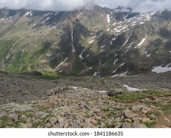 view from Niederl saddle on Nurnberger Hutte mountain hut and snow-capped peaks at Stubai hiking trail, Stubai Hohenweg, Summer rocky alpine landscape of Tyrol, Stubai Alps, Austria - Powered by Shutterstock