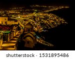 A view at night looking down over the settlement of Thira, Santorini in summertime