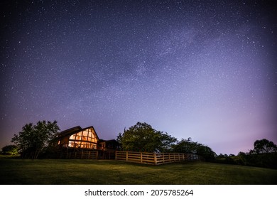 View of night sky and the Milky Way with a house in rural Kentucky in the foreground - Powered by Shutterstock