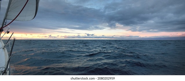 A View To The North Sea From A Sailing Boat At Sunset. Dramatic Stormy Sky, Sun Rays Through The Dark Clouds. Epic Seascape. Deep Cyclone In Winter. Norway. Concept Image, Climate Change,  Ecology