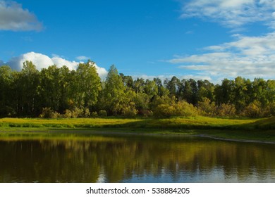 View of a northern oxbow lake in Siberia with taiga forest in the background