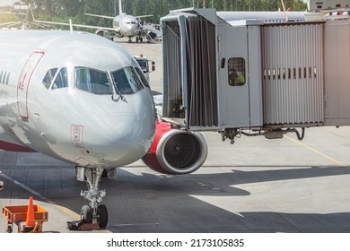 View Of The Nose And Cockpit Of The Aircraft And The Docking Gangway Air Bridge