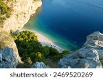 View of Nugal Beach in Makarska from above. Looking down on a dreamy turquoise bay, tucked between dramatic rock walls, in Southern Dalmatia, Croatia.