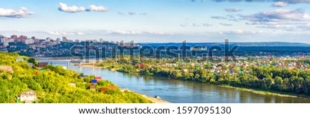 View from observation deck to residential districts of Ufa and Belaya river in summer evening at sunset. Beautiful cityscape, popular view of Ufa city, capital of Bashkiria