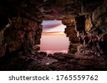 View of the ocean from inside a cave. Perspective photo using the cave opening as a window.