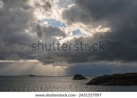 view of the ocean and small islands from Saint Malo, dramatic sky with clouds in summer