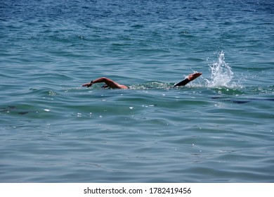 View Of An Ocean Swimmer Partially Under Water