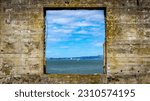View of the ocean through an old window on Alcatraz Island 