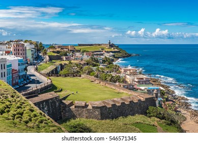 View of ocean towards San Felipe del Morro from Castillo de San Cristobal with castle wall and grass fields in between
