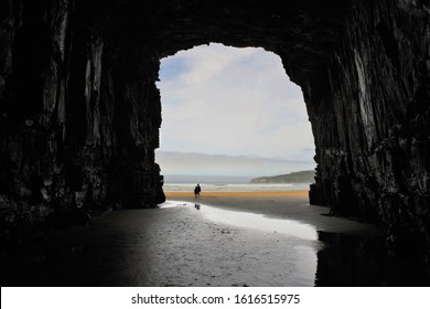 View off the ocean from inside the cave. Silouette of a couple