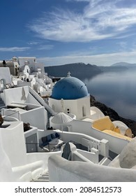 View of oia in santorini and part of caldera, blue church