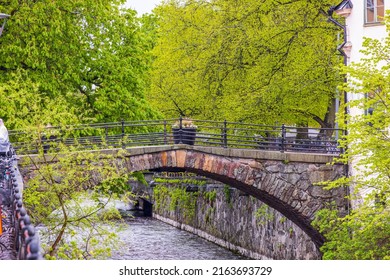 View of old bridge across river on spring day. Europe. Sweden. Uppsala.