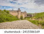 View of old castle Hotin near the river. Khotyn Fortress - medieval castle on yellow autumn hills. Ukraine, Eastern Europe. The architecture of the Middle Ages in our time.