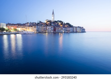 A view of the old city core with the Saint Euphemia church and bell tower at sunset in Rovinj, Croatia.