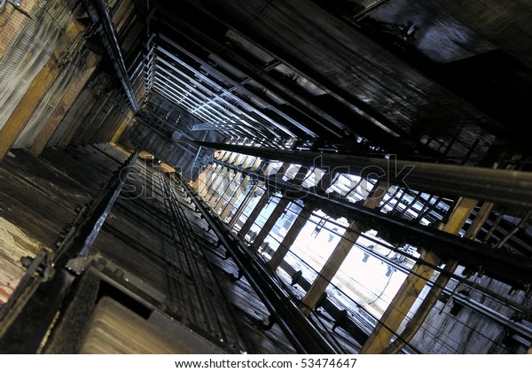 View up an old freight\
elevator shaft.