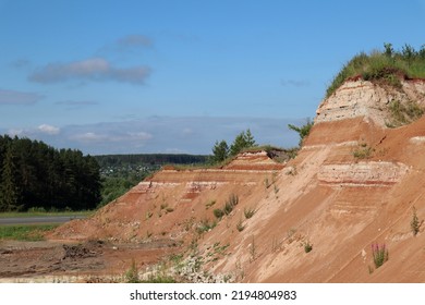 View Of An Old, Grassy Quarry. The Village Is In The Background. Sovetsky District. Republic Of Mari-El.