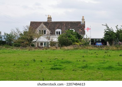 View Of An Old House On Farmland In Rural England