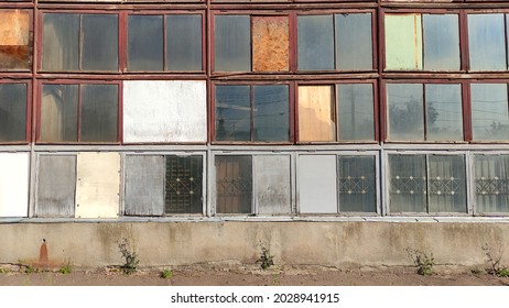 View of an old industrial building, an old factory. Wooden windows in an old factory, abandoned building 