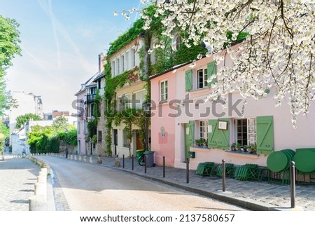 View of old street in quarter Montmartre in Paris, France. Cozy cityscape of Paris at spring. Architecture and landmarks of Paris.