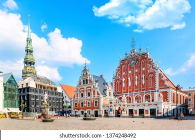 View of the Old Town Ratslaukums square, Roland Statue, The Blackheads House near St Peters Cathedral against blue sky in Riga, Latvia. Summer sunny day