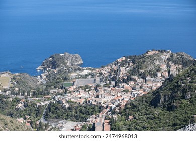 View from the old town of Taormina in Sicily towards the seaside village Mazzarò - Powered by Shutterstock