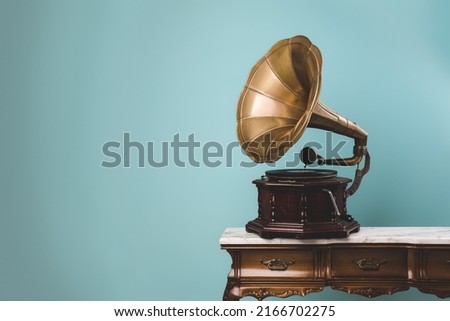 View of an old vintage gramophone on a table with copy space. Music and retro style concept.