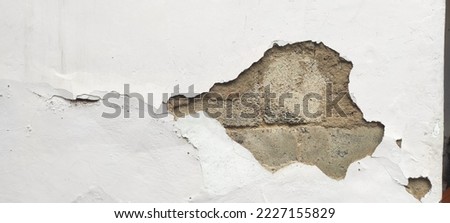 View of Old wall with scratch, old paint, wall texture, cracked wall and porous wall cement,  earthquake.