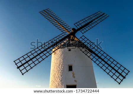 View of an old windmill located in the town of Consuegra (La Mancha, Spain), on the tourist route of the Cervantes mills (Don Quixote).