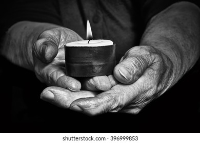 View Of An Old Woman Hands Holding A Burning Candle