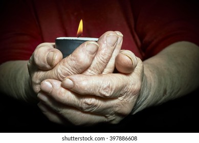 View Of An Old Woman Hands Holding A Burning Candle