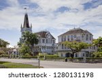 View of an old, wooden,  fabulous Gothic building with a spire and towers on a clear Sunny day, Georgetown city hall, Guyana. Architecture, style, world tourism.