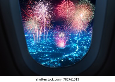 View On Air Plane Window Of Fireworks Over Blue Night City For Happy New Year Celebration