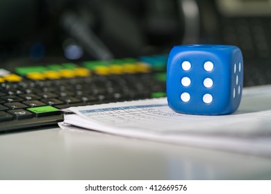 View On Blue Dice With Six Dots On A Trading Blotter Near Colorful Financial Keyboard.