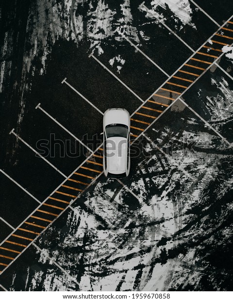 View on the car\
from the air. Car in an empty parking lot. View of the vehicle from\
the drone. Travel by car.