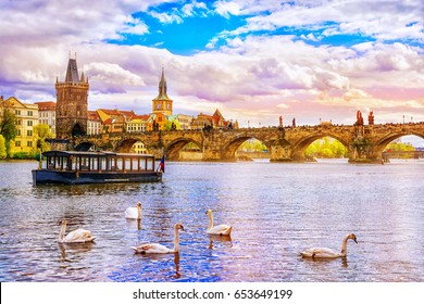 View on Charles bridge and swans on Vltava river in Prague at sunset, Czech Republic
