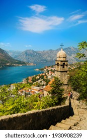 View on Church, ancient walls, mountains and sea in Kotor old town. Montenegro, Kotor bay. Top view