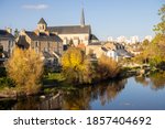 View on the clain river in Poitiers. There is a church. Sunny day, photographed in the autum.