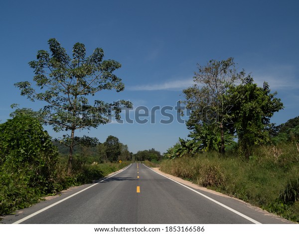 A view on\
the curved road, on the road overlooking the traffic sign. With far\
side, picture Is a view of the mountains and the sky that can be\
seen comfortably On the day of our\
trip