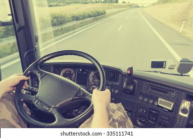 View On The Dashboard Of The Truck Driving. The Driver Is Holding The Steering Wheel. Empty Highway Is In Front Of The Car. Edited As Instagram Effect.