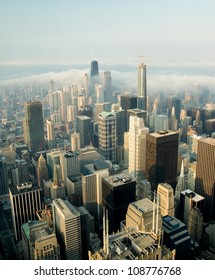 A View On A Day With Clouds Rolling Over Chicago City Downtown Skyline With Aerial View Of  Buildings Covered Partially With Clouds