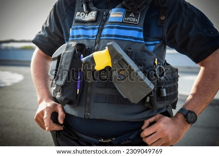 view on an electric taser of a french policeman in the street