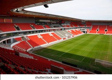 View On An Empty Football (soccer) Stadium With Red Seats.