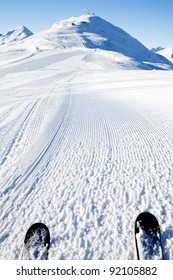 View On Empty Fresh-made Downhill Ski Slope And Mountains On A Sunny Day