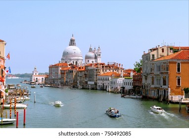 View on Grand Canal and the church Basilica di Santa Maria della Salute from the Academia bridge on summer day. Venice, Italy.